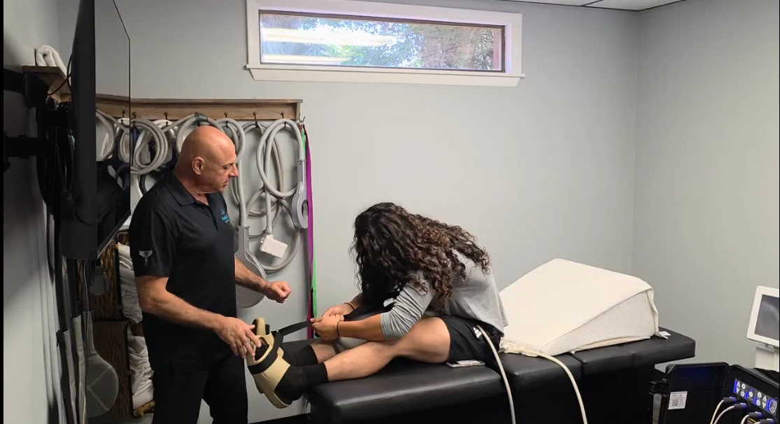Joe guiding a seated stretch at PulseLight Hyperbaric